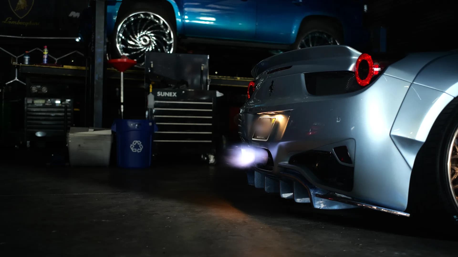 Widebody Ferrari 458 on the shop floor with flame visible at the exhaust outlet