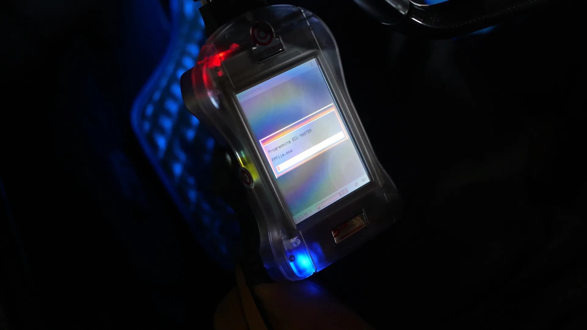 Handheld ECU programmer writing a calibration file to the Ferrari 458 engine control unit